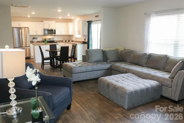 a view of a living room kitchen and a dining table with a large window