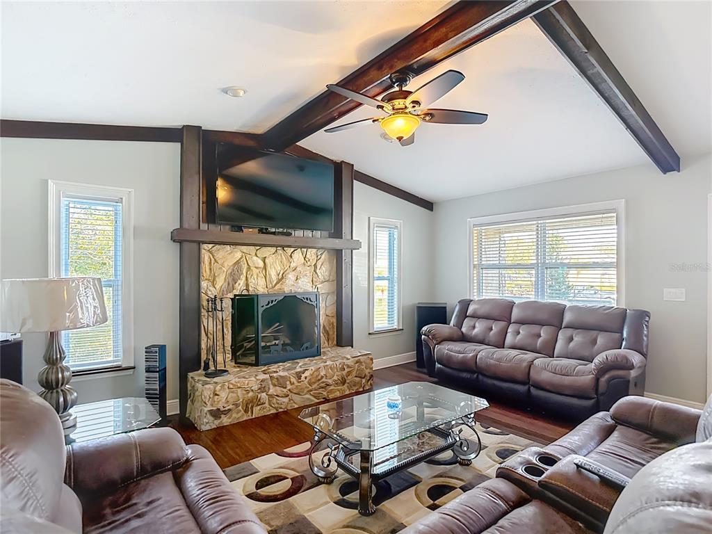 5904 Springrun Court Holiday, FL 34690 - Photo 13 of 79 a living room with furniture and a fireplace