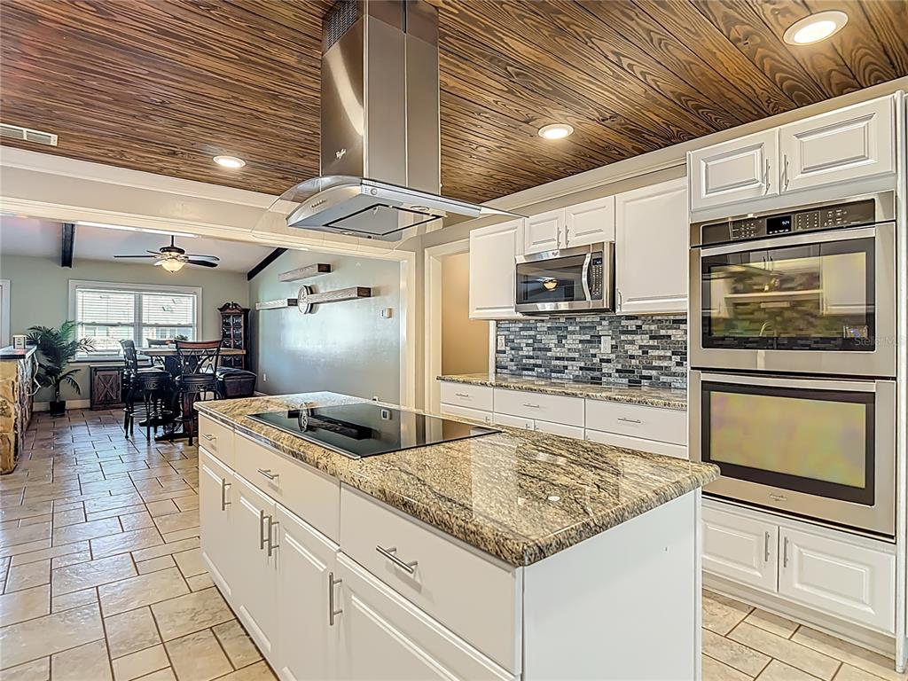 5904 Springrun Court Holiday, FL 34690 - Photo 25 of 79 a kitchen with stainless steel appliances granite countertop a sink stove and cabinets