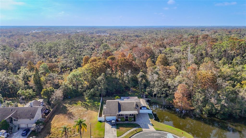 5904 Springrun Court Holiday, FL 34690 - Photo 3 of 79 an aerial view of a house with a yard and lake view