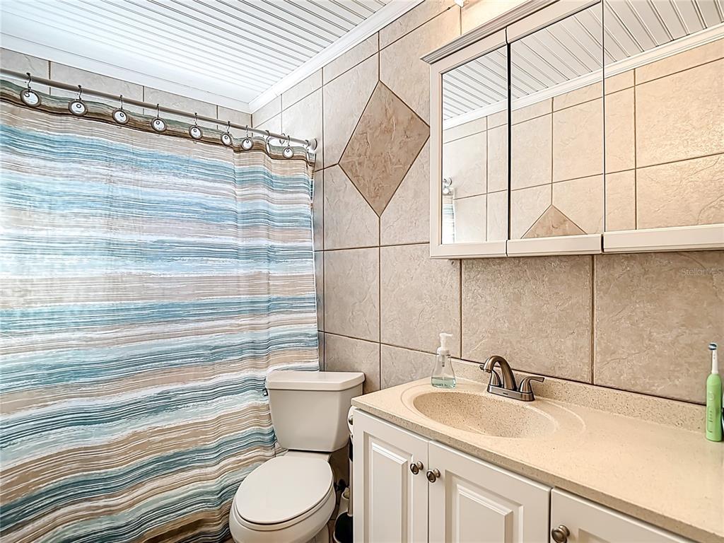 5904 Springrun Court Holiday, FL 34690 - Photo 40 of 79 a bathroom with a sink a toilet and shower