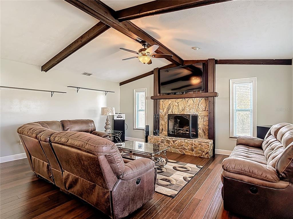 5904 Springrun Court Holiday, FL 34690 - Photo 10 of 79 a living room with furniture and a fireplace
