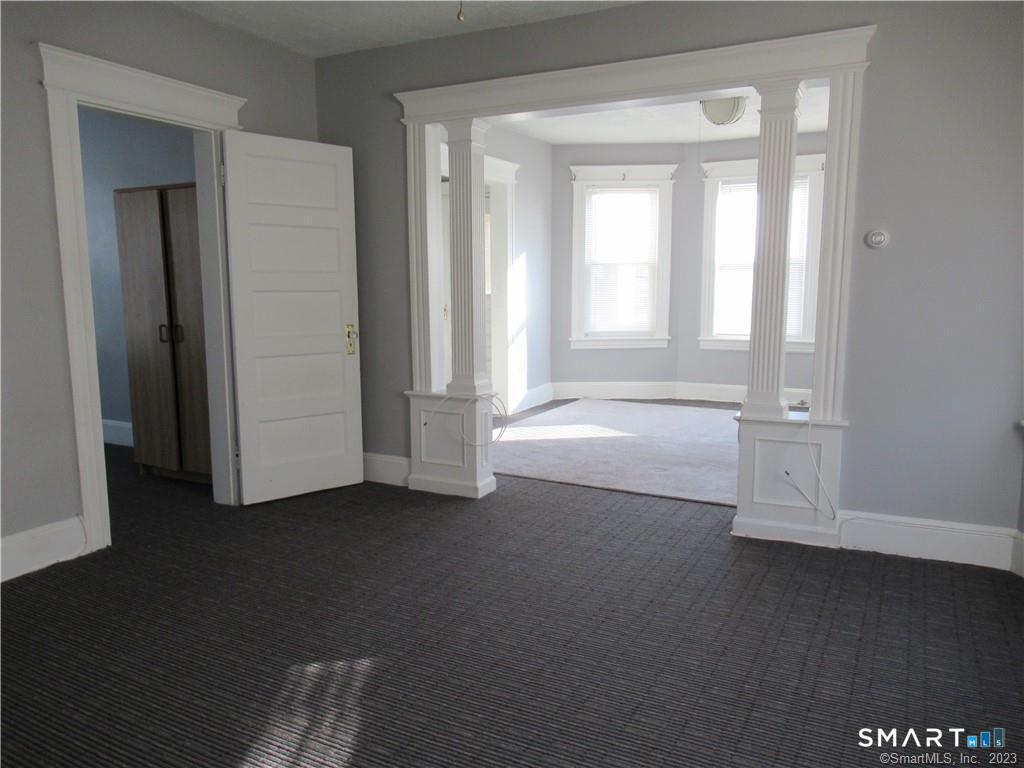 166 Booth Street Stratford, CT 06614 - Photo 4 of 12 an empty room with windows and closet
