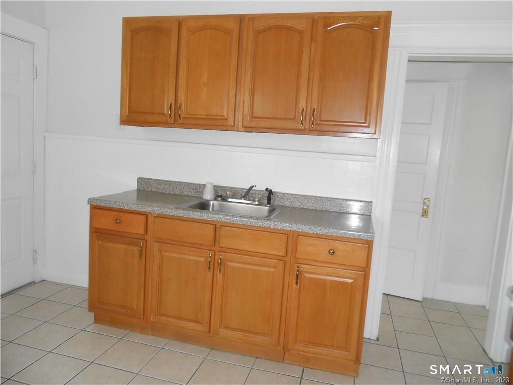 166 Booth Street Stratford, CT 06614 - Photo 7 of 12 a sink with a cabinets