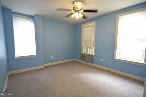 a view of an empty room with closet