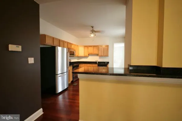 a kitchen with stainless steel appliances a refrigerator and a stove top oven