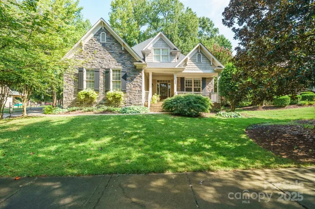 a front view of a house with garden and porch