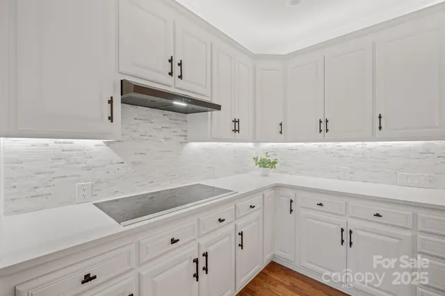 a kitchen with white cabinets and white appliances