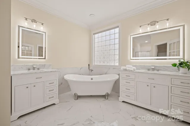 a spacious bathroom with 2 sink tub and a mirror
