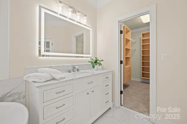 a bathroom with a granite countertop sink mirror and