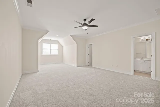 a view of empty room with window and ceiling fan