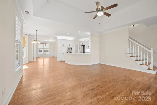 a view interior of a house with wooden floor and a ceiling fan