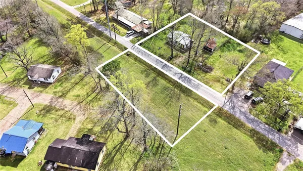 an aerial view of residential houses with outdoor space and swimming pool