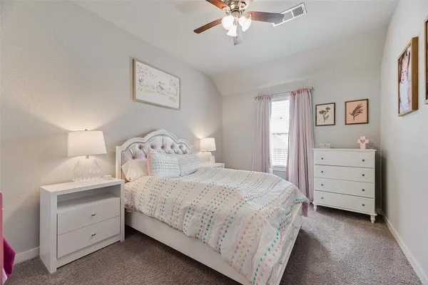a bedroom with a bed and a dresser
