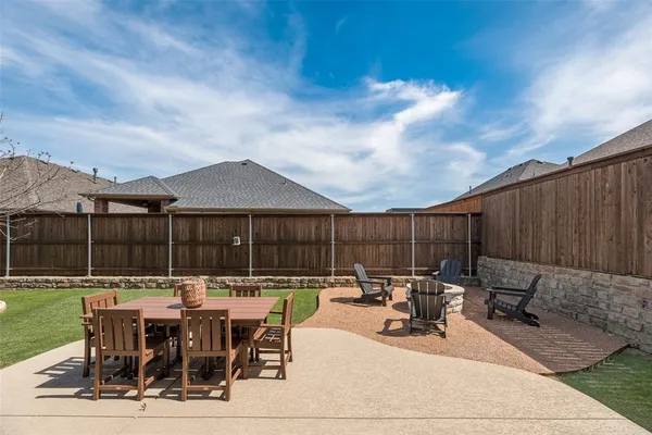 a view of a patio with dining table and chairs with a barbeque grill and plants