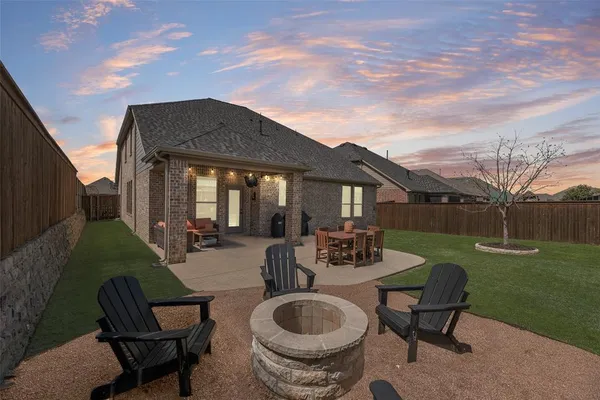 a view of a house with backyard sitting area and garden