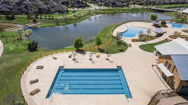 an aerial view of a house with garden space and lake view