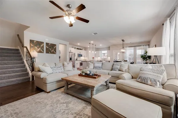 a living room with furniture and a chandelier