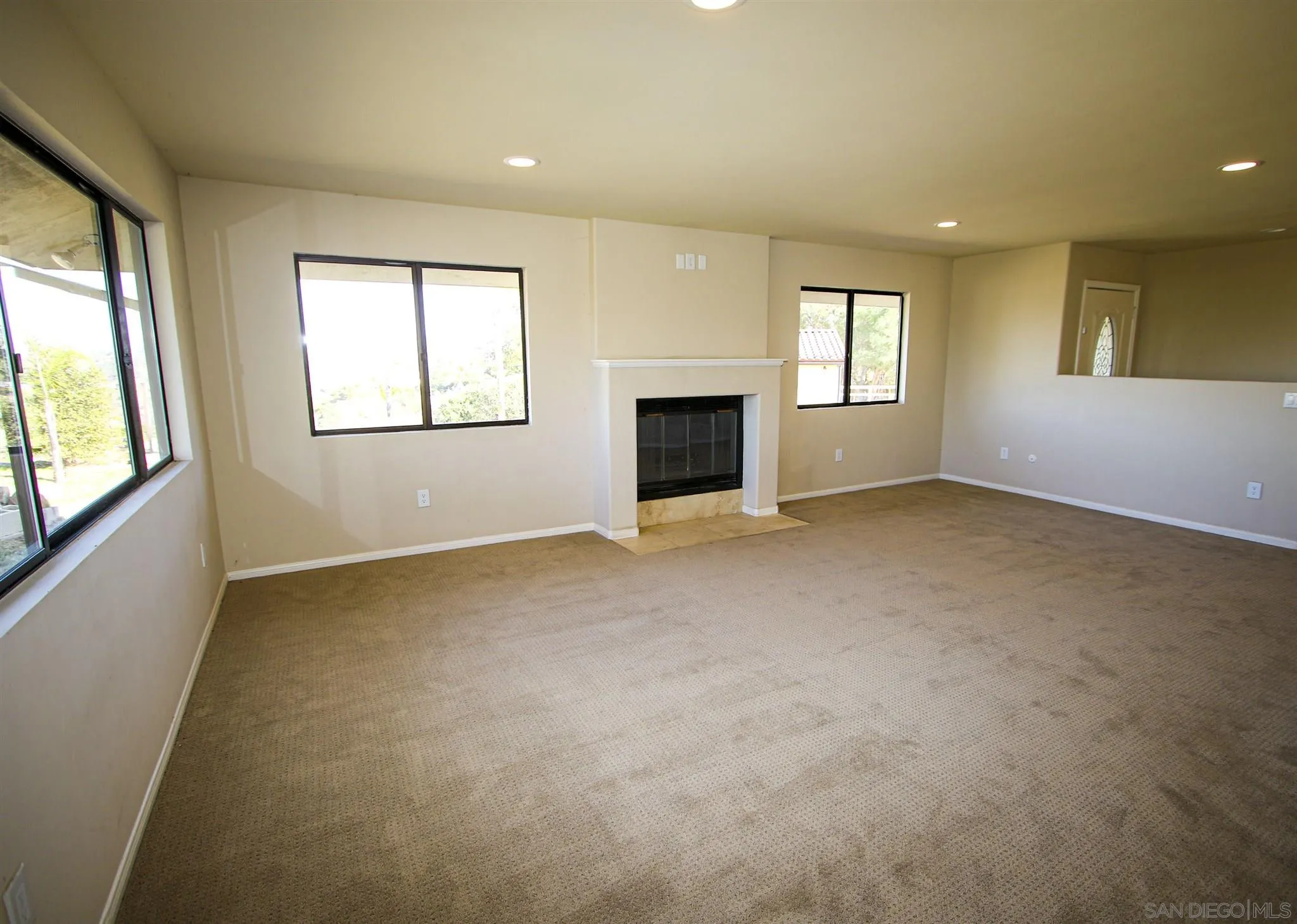 28620 Gordon Hill Road Valley Center, CA 92082 - Photo 5 of 15 an empty room with windows and fireplace
