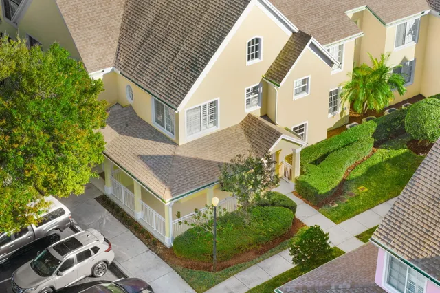 an aerial view of a house with a yard