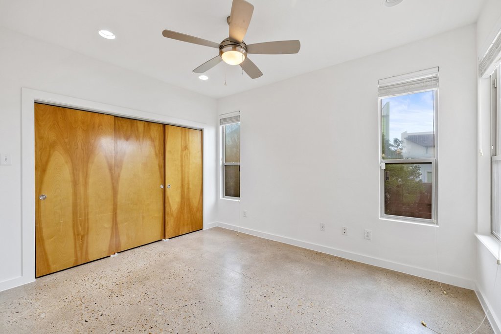 7412 Ava Lane Austin, TX 78724 - Photo 12 of 28 Unfurnished bedroom with a ceiling fan, recessed lighting, a closet, and speckled floor