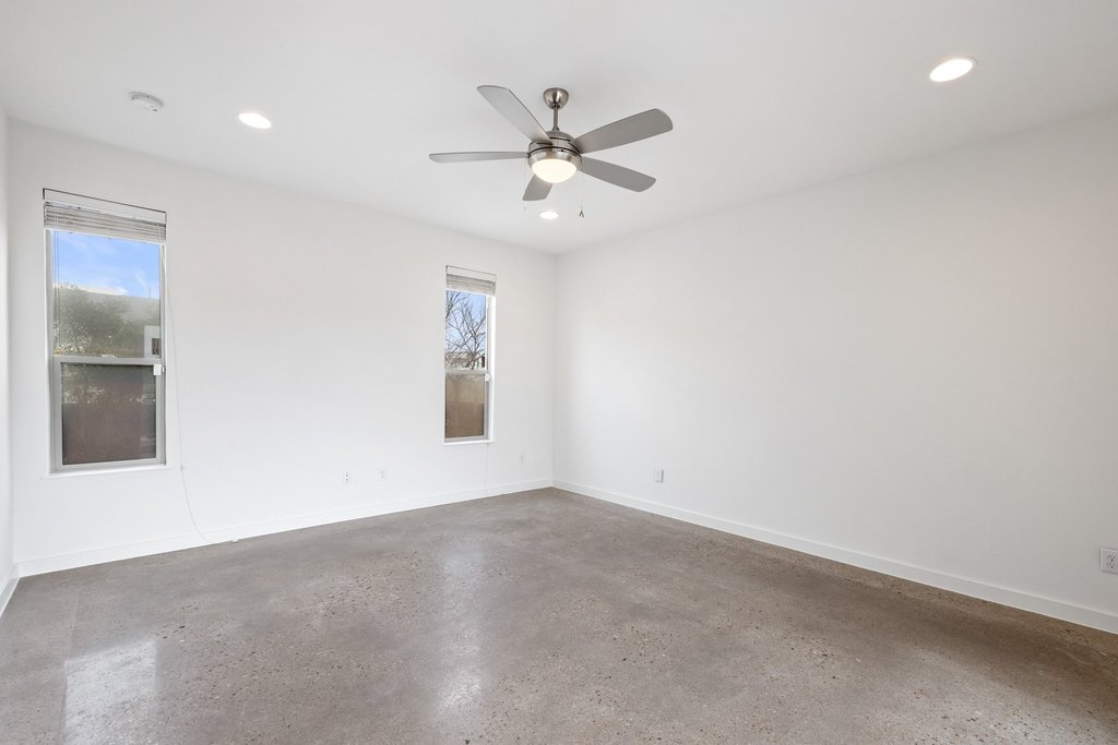 7412 Ava Lane Austin, TX 78724 - Photo 13 of 28 Unfurnished room with healthy amount of natural light, concrete flooring, a ceiling fan, and recessed lighting