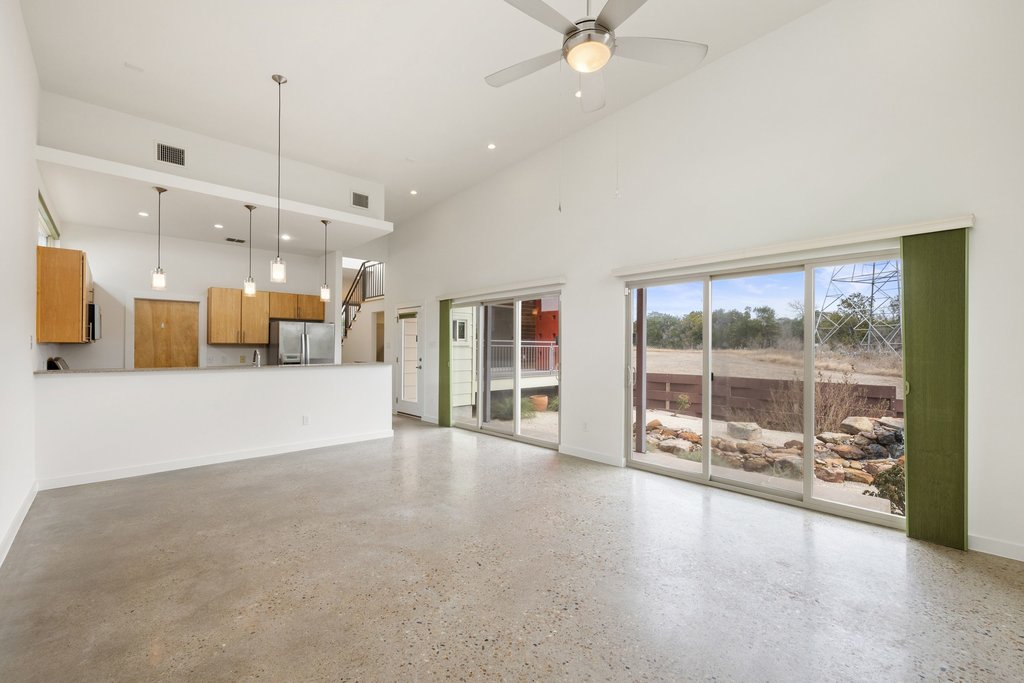7412 Ava Lane Austin, TX 78724 - Photo 7 of 28 Living room featuring a high ceiling and a ceiling fan