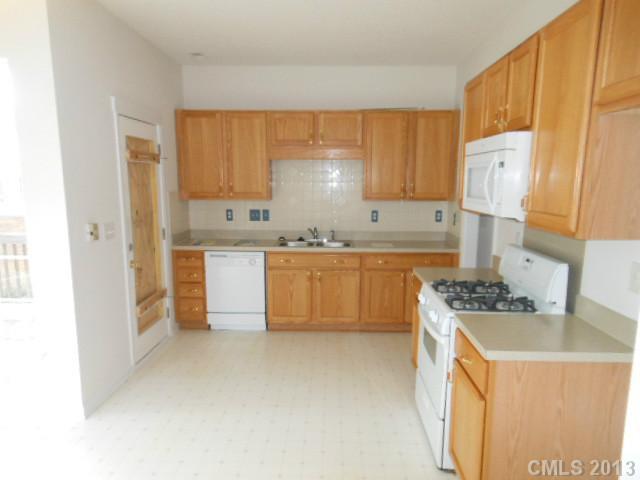 4513 Hyperion Court Charlotte, NC 28216 - Photo 2 of 16 a kitchen with a sink a stove and cabinets