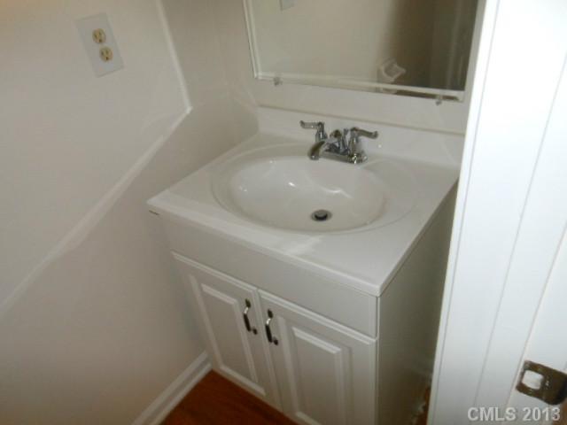 4513 Hyperion Court Charlotte, NC 28216 - Photo 12 of 16 a bathroom with a sink and mirror