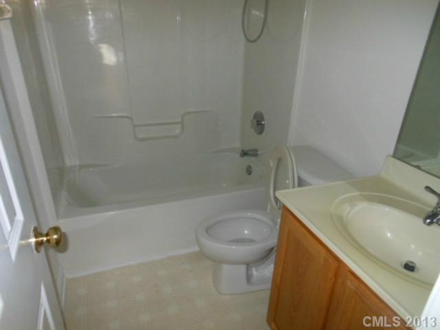 4513 Hyperion Court Charlotte, NC 28216 - Photo 14 of 16 a bathroom with a sink a toilet and shower