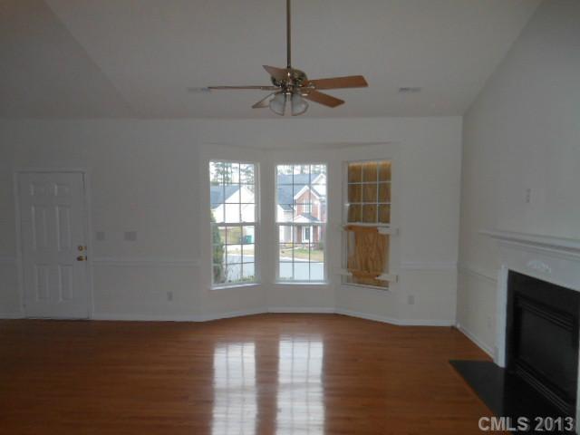 4513 Hyperion Court Charlotte, NC 28216 - Photo 3 of 16 a view of an empty room with a window and wooden floor