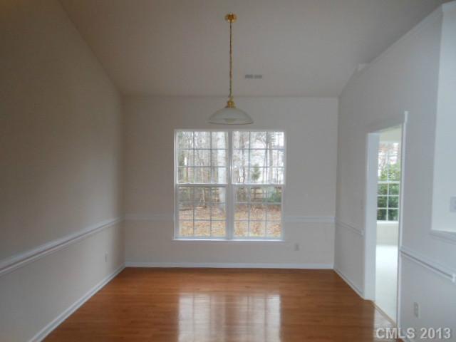 4513 Hyperion Court Charlotte, NC 28216 - Photo 5 of 16 an empty room with windows and ceiling fan