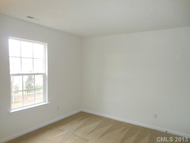4513 Hyperion Court Charlotte, NC 28216 - Photo 8 of 16 an empty room with a window