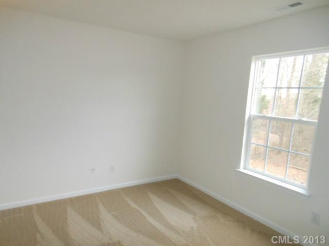 4513 Hyperion Court Charlotte, NC 28216 - Photo 9 of 16 an empty room with a window