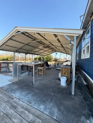 a view of house with yard and car parked