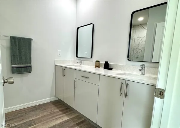 a bathroom with a double vanity sink and mirror