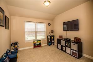 1409 Rosson Road Little Elm, TX 75068 - Photo 8 of 34 Carpeted room with a vaulted ceiling and a flush-mount ceiling light