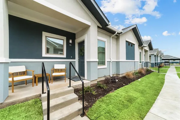 a view of backyard of house with outdoor seating