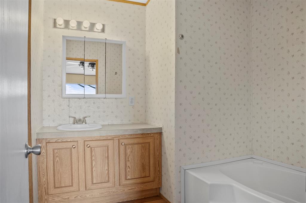 242 Private Road 4732 Rhome, TX 76078 - Photo 17 of 33 a bathroom with a sink and a bathtub
