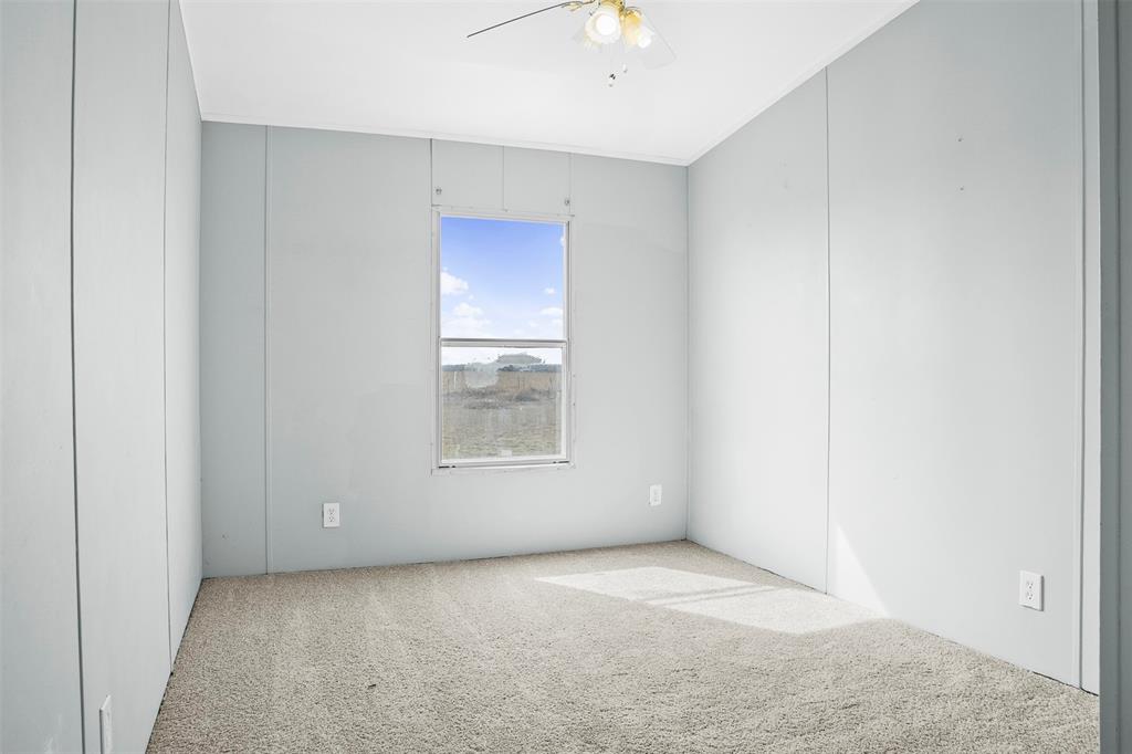 242 Private Road 4732 Rhome, TX 76078 - Photo 22 of 33 an empty room with a empty space and windows