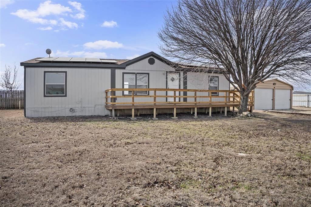 242 Private Road 4732 Rhome, TX 76078 - Photo 25 of 33 a view of a house with a yard and wooden fence