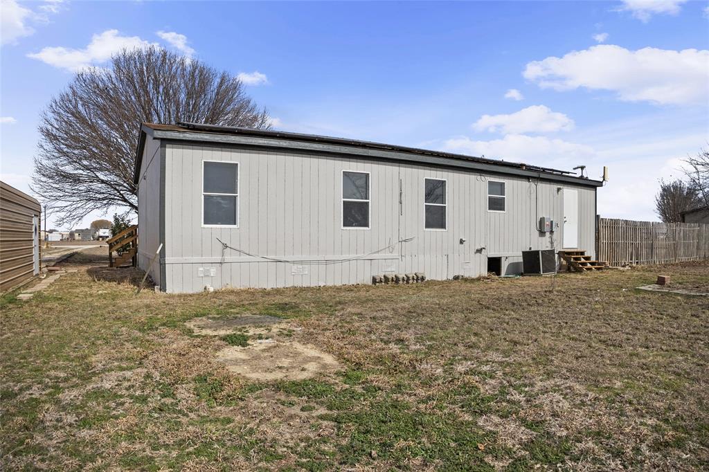 242 Private Road 4732 Rhome, TX 76078 - Photo 29 of 33 a front view of a house with a yard