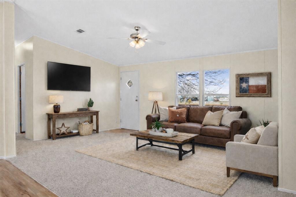 242 Private Road 4732 Rhome, TX 76078 - Photo 5 of 33 a living room with furniture and a flat screen tv