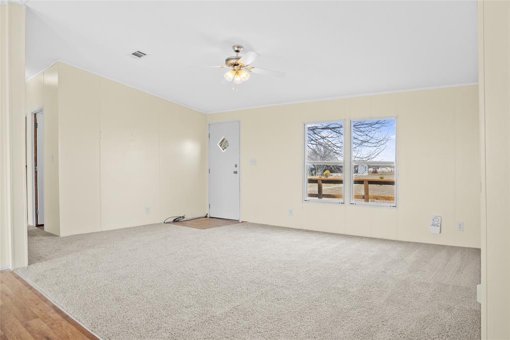 242 Private Road 4732 Rhome, TX 76078 - Photo 6 of 33 an empty room with a painting on the wall