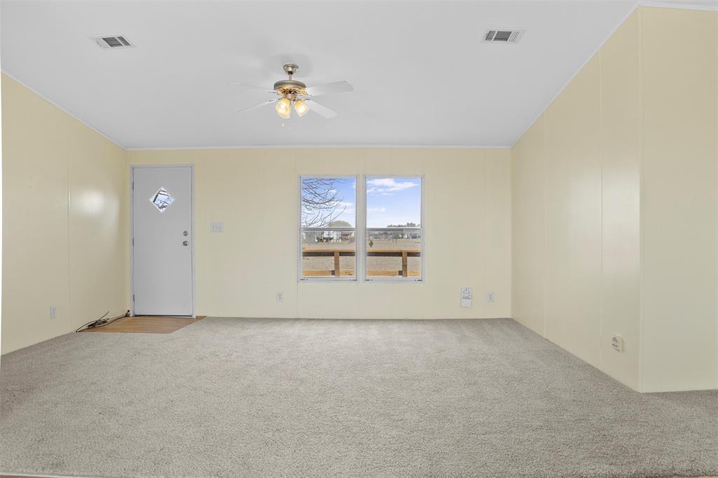 242 Private Road 4732 Rhome, TX 76078 - Photo 7 of 33 an empty room with a empty space and window