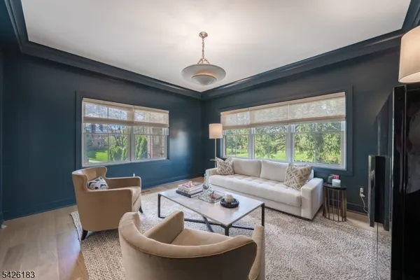 a living room with furniture a lamp and a large window
