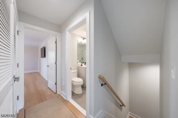 a bathroom with a sink toilet vanity and shower