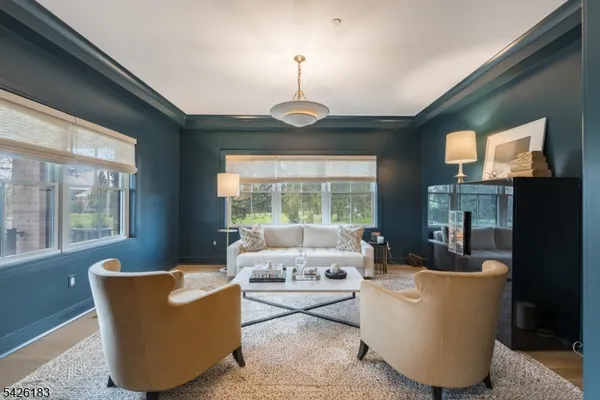 a living room with couches and a chandelier