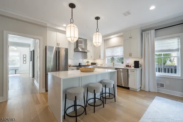 a large kitchen with a table and chairs