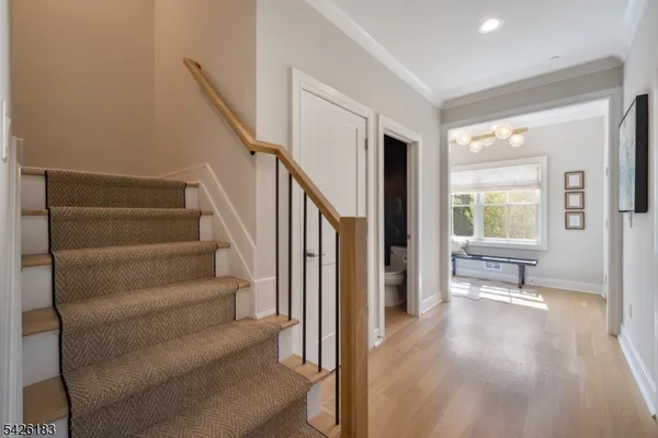 a large kitchen with kitchen island a large counter space a sink stainless steel appliances and cabinets